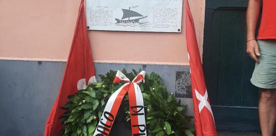 La corona d'alloro deposta sulla targa commemorativa