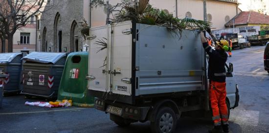 Un giardiniere di Aster riempie un porter di materiale verde di scarto Un giardiniere di Aster riempie un porter di materiale verde di scarto