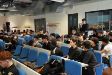 Uno studente fa una domanda al Capitano David-Marks in aula magna