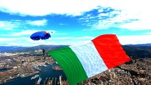 Un enorme tricolore plana insieme a un paracadutista della Folgore
