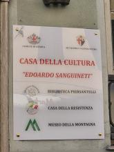 La targa che recita "Casa della Cultura Edoardo Sanguineti" e i nomi delle strutture ospitate all'interno