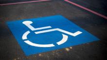 simbolo blu parcheggio disabili su asfalto